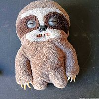 Full view of brown sloth-style Fuggler plush doll