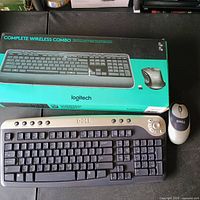 Front view showing Logitech boxed combo, Dell keyboard, Dell mouse