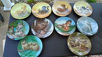 Front view of all ten decorative plates arranged on table