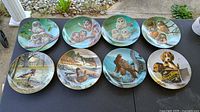 Front view showing eight wildlife themed plates