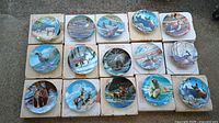 All 15 wildlife plates displayed on boxes, fronts visible