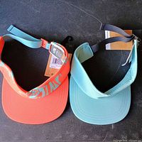 Two The North Face visors showing colors and tags