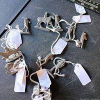 Group of 11 unpainted lead soldiers with tags attached