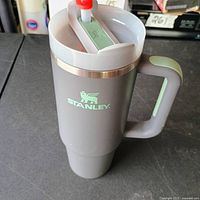 Full view of grey Stanley mug with handle and logo