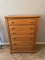 Front view of oak dresser showing five drawers and handles