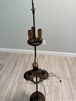 Full view of brass floor lamp showing four-socket cluster and smoking tray