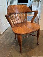 front angled view of antique oak armchair