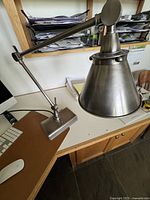 full view of brushed nickel desk lamp on desk