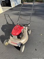 Full view of Honda push mower showing deck, engine, wheels, and handle
