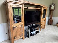 Front view of entertainment center with TV in opening