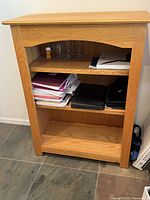 front view of oak bookshelf with three shelves