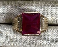 Front view showing square red glass stone and shoulder detailing