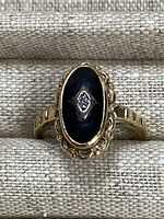 Front view showing oval black onyx and central diamond