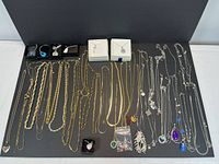 Full overview of all necklaces laid flat on black mat