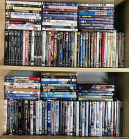 Shelf of assorted DVDs including various movie and TV titles