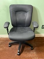 Front view of ergonomic office chair with fabric upholstery showing seat, backrest, armrests, and caster wheels on black plastic base