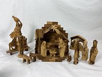 Full set of nativity figures and stable shown from front angle, including additional wooden figures.