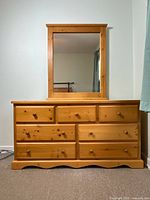 Front view of pine dresser with seven drawers and attached mirror, showing size and condition.