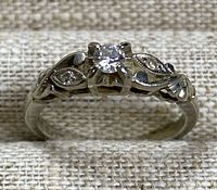 Front view showing center diamond and side leaf motifs