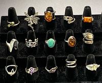 Front view of 15 sterling silver rings displayed in rows