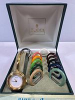 Full set in open Gucci box showing watch and bezels