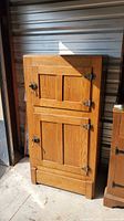 Front view of oak ice box showing doors, hinges, latches