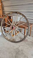Full view of wagon wheel leaning against table