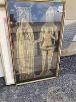 Full view of framed brass rubbing artwork showing both figures