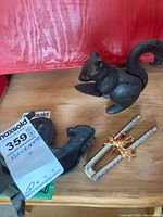 Overall view of cast iron squirrel nutcracker, metal tongs nutcracker