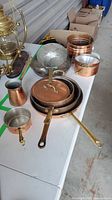 Group shot of copper cookware pieces on table