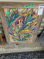 Full view of framed folk art painting showing birds and foliage, dimension tag visible