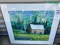 Full view of framed watercolor with cabin and forest