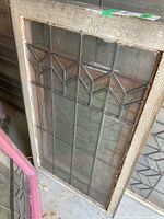 Full view of leaded glass window in wood frame