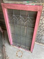 Full view of stained glass window in pink frame