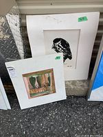 Both matted prints leaning against wall: Night Heron lithograph and abstract still life watercolor