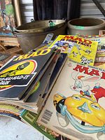 Stack of Mad Magazine issues showing various covers and moderate wear