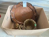 Box containing large hammered platter, fluted bowl, shell dishes, brass stand, other small brass pieces