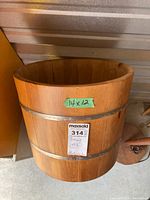 Exterior of wooden bucket showing size label and metal bands