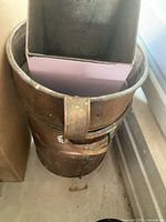 Copper boiler showing cylindrical shape, riveted seam and side strap handle