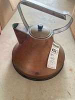 Entire kettle showing handle, lid, spout, patina