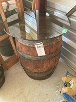 Full view of barrel table showing glass top and metal-banded wood barrel