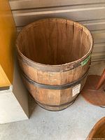 Full view of wooden barrel beside other objects