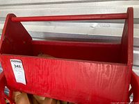 Overall view of red wooden toolbox