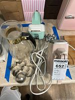 Wide photo showing all items together on countertop, including mixer, carafe and cookie cutters.