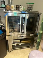 Front view of oven with glass doors and lower storage space