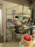 Side angled view of shelving unit filled with kitchen containers and bowls (not included).