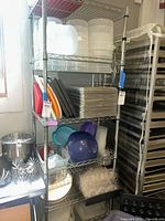 Front and side view of wire shelving unit with various kitchen items on each shelf.