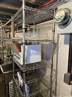 Full view of the shelving unit in basement setting with various items on shelves.