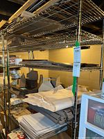 Full view of the wire shelving unit loaded with various items showing adjustable shelves.