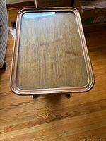 Top view showing rectangular glass top over wood surface with visible grain and rounded wood edges.